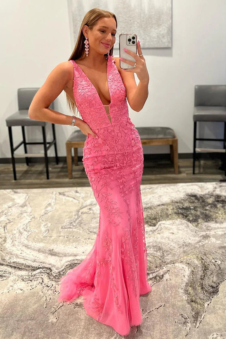 Pink mermaid prom dress with deep V-neck, appliques, and rhinestones.