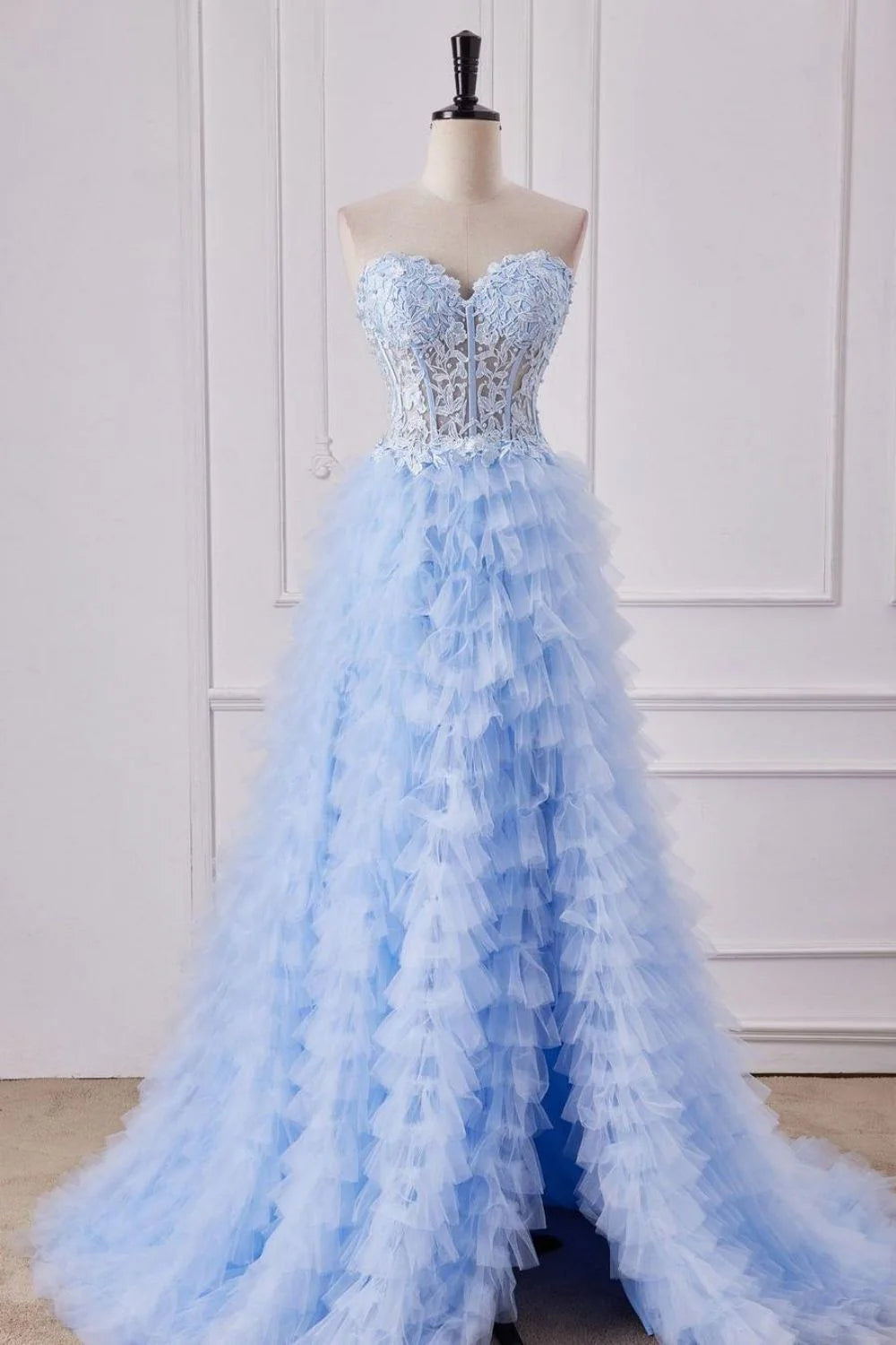 Light blue A-line prom dress with sweetheart neckline, lace applique bodice, and flowing tulle skirt.