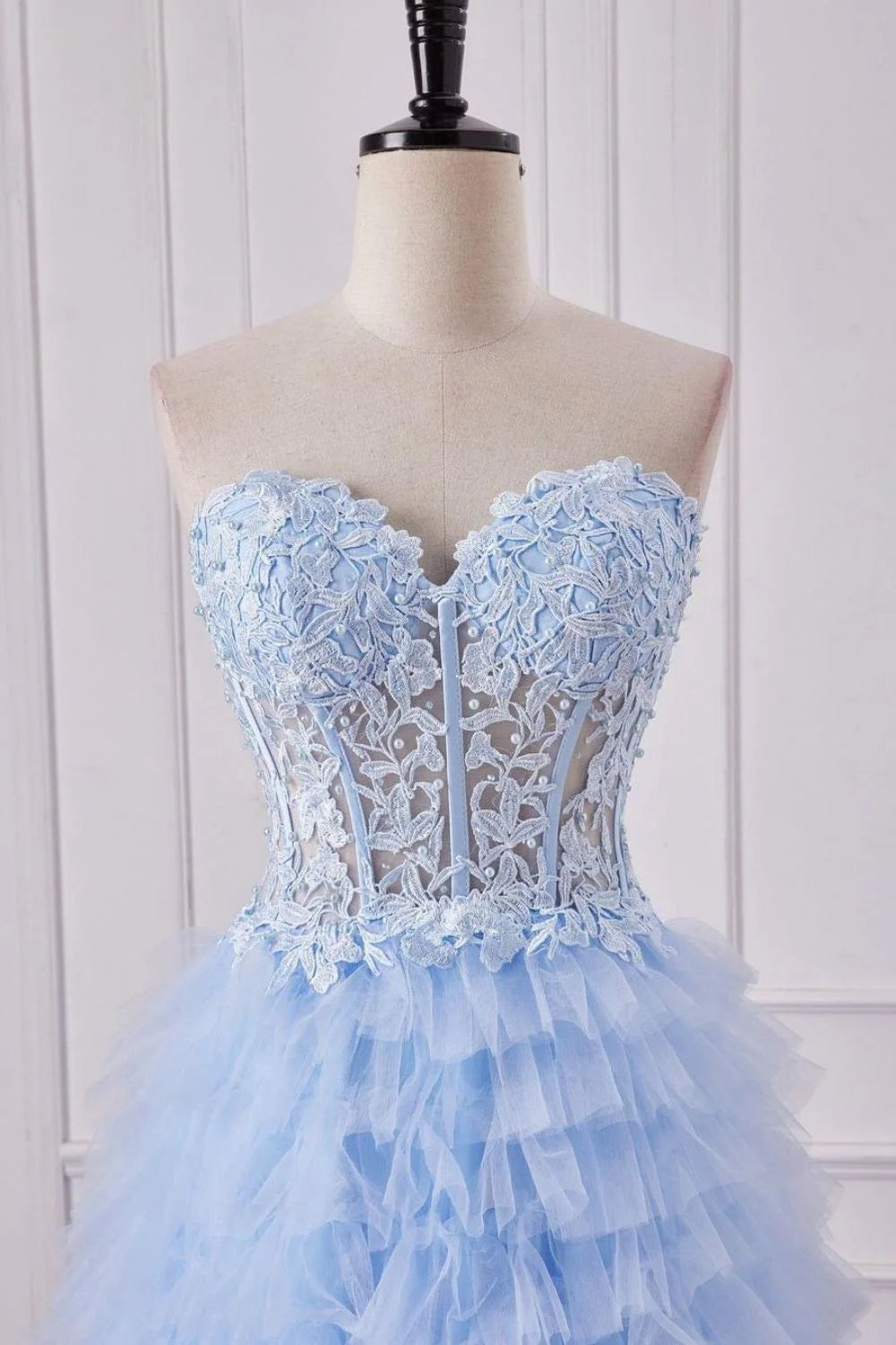 Full view of a light blue A-line prom dress featuring a sweetheart neckline and intricate lace details.