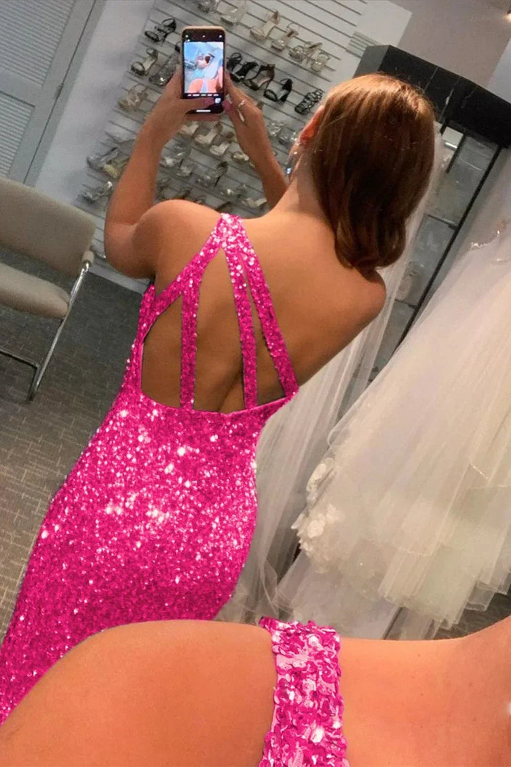Side view of hot pink sequin mermaid gown, showing silhouette.