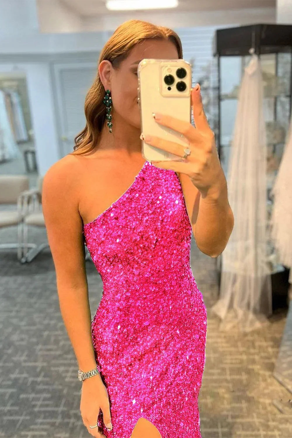 Back view of hot pink prom dress with one-shoulder and criss-cross straps.
