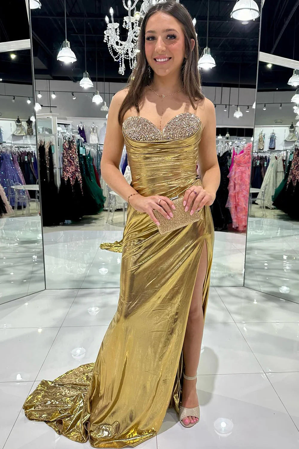 Back view of the silver mermaid prom dress, highlighting the zipper closure and train.