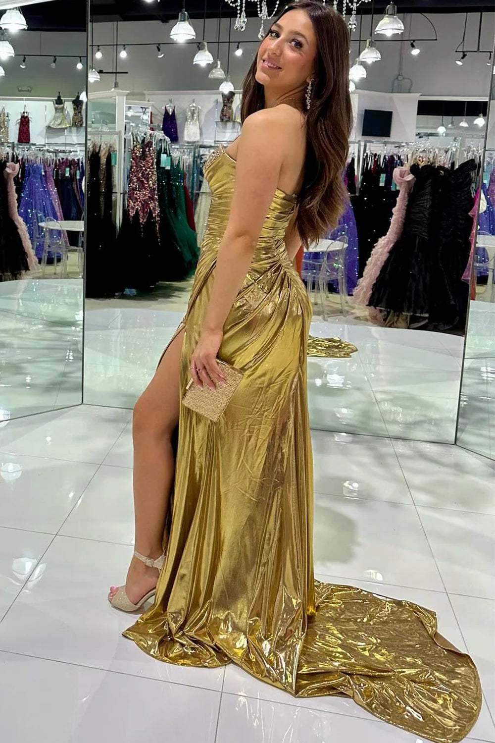 Front view of a woman posing in a shimmering silver mermaid formal gown.