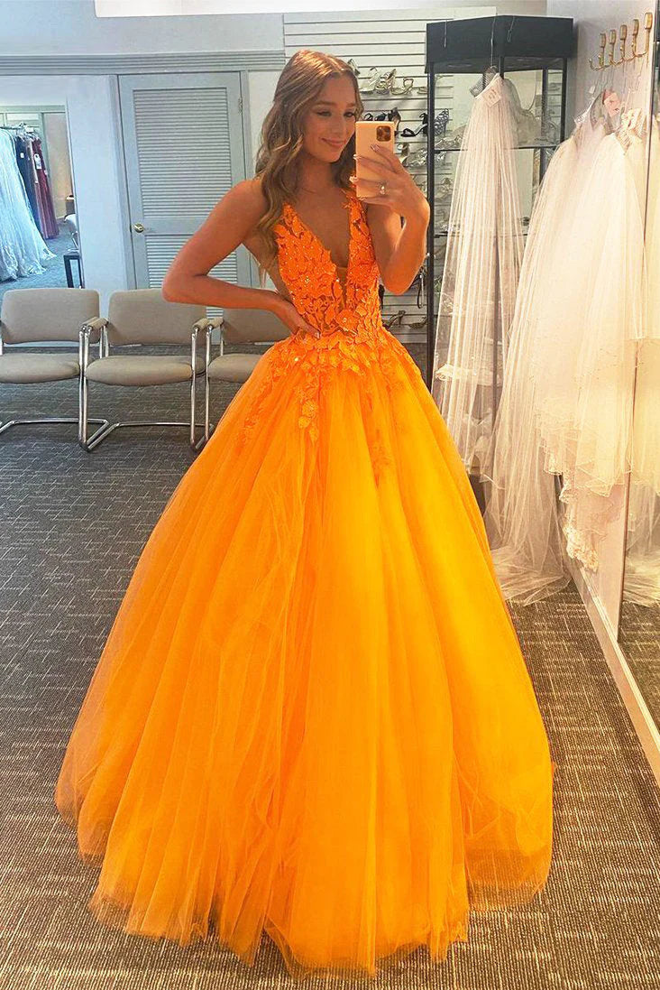 Woman wearing an elegant A-Line deep V-neck floor-length prom dress with intricate appliques.