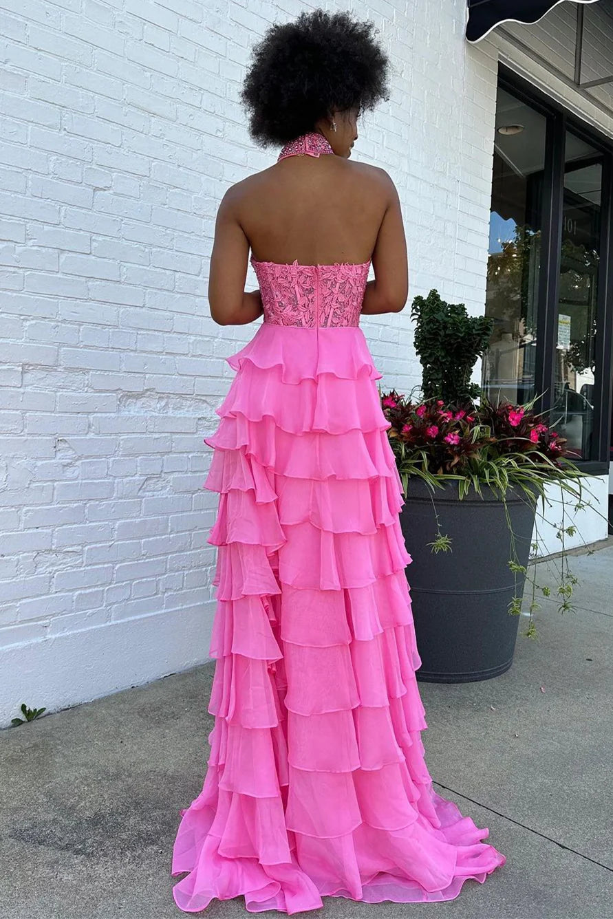 Back view of a woman wearing a pink A-line prom dress with a zipper closure.