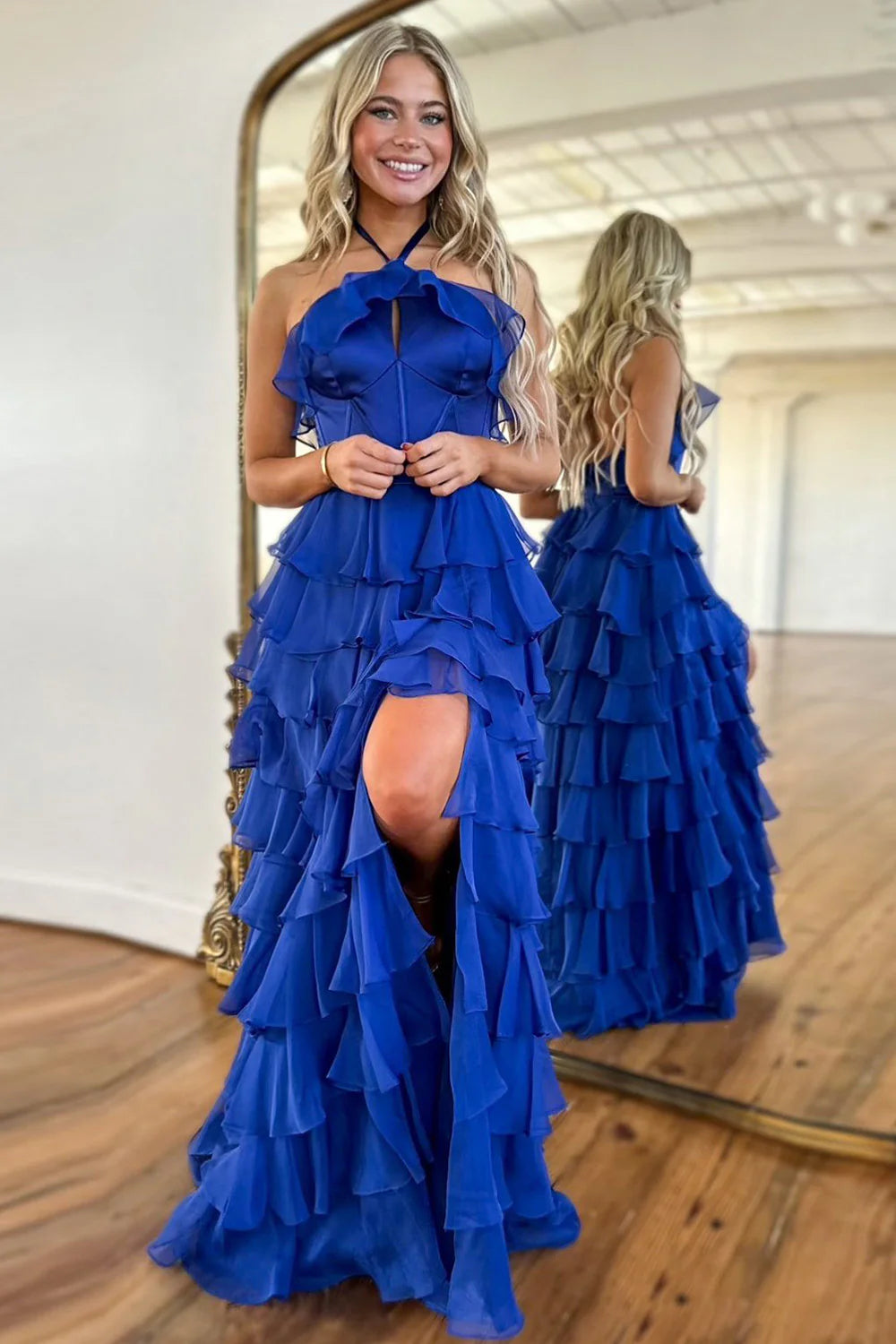 Royal blue A-line prom dress with halter neck, ruffle tiered skirt, and high slit.