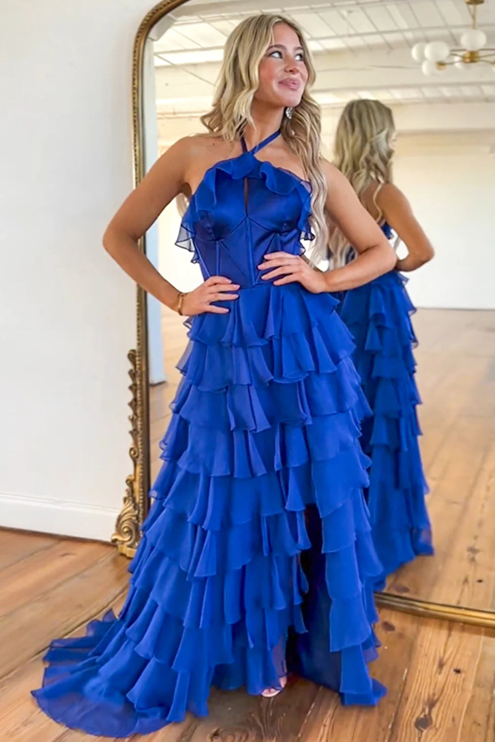 Elegant royal blue halter neck prom dress with ruffle tiers and a side slit.