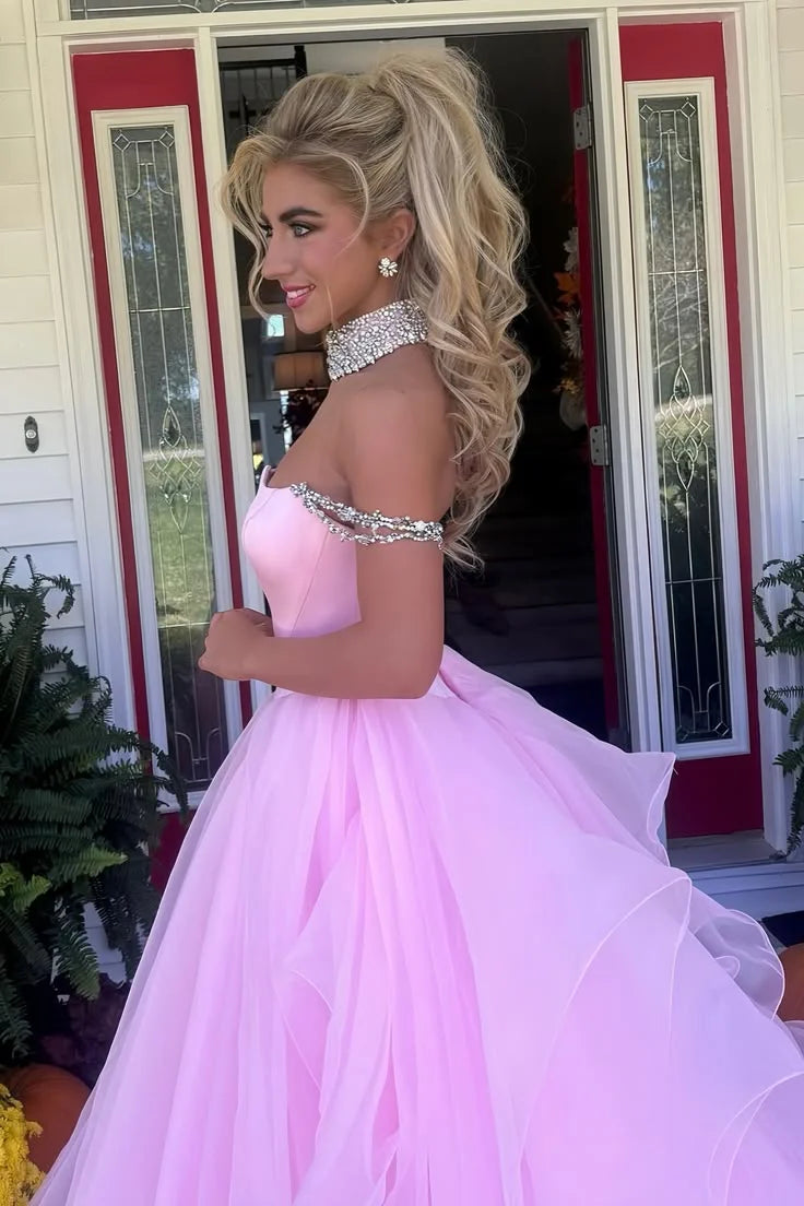 Front view of a model showcasing the pink off-shoulder A-line prom dress with intricate beading.