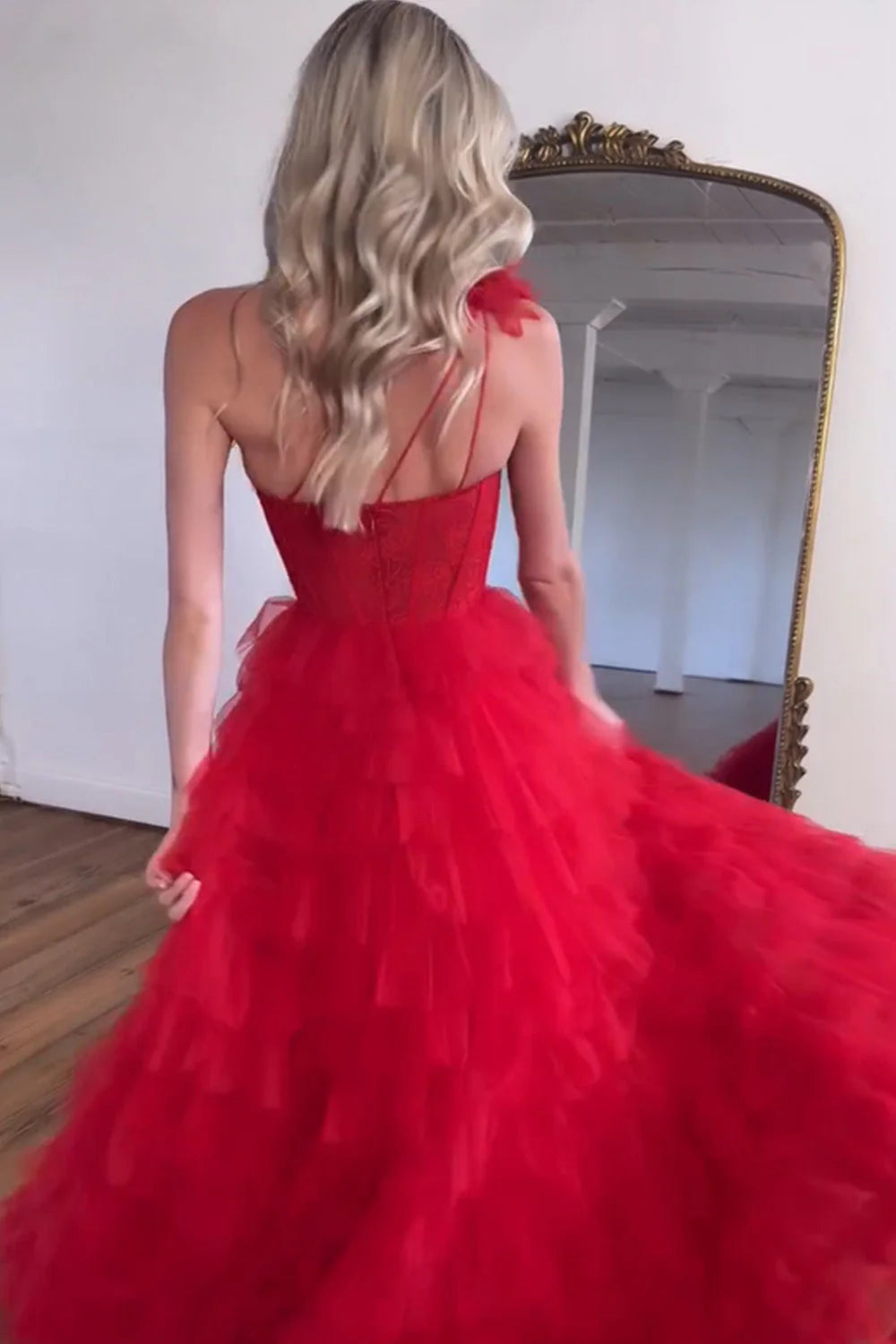 Full view of elegant red A-line prom dress featuring a one-shoulder design and ruffled skirt.