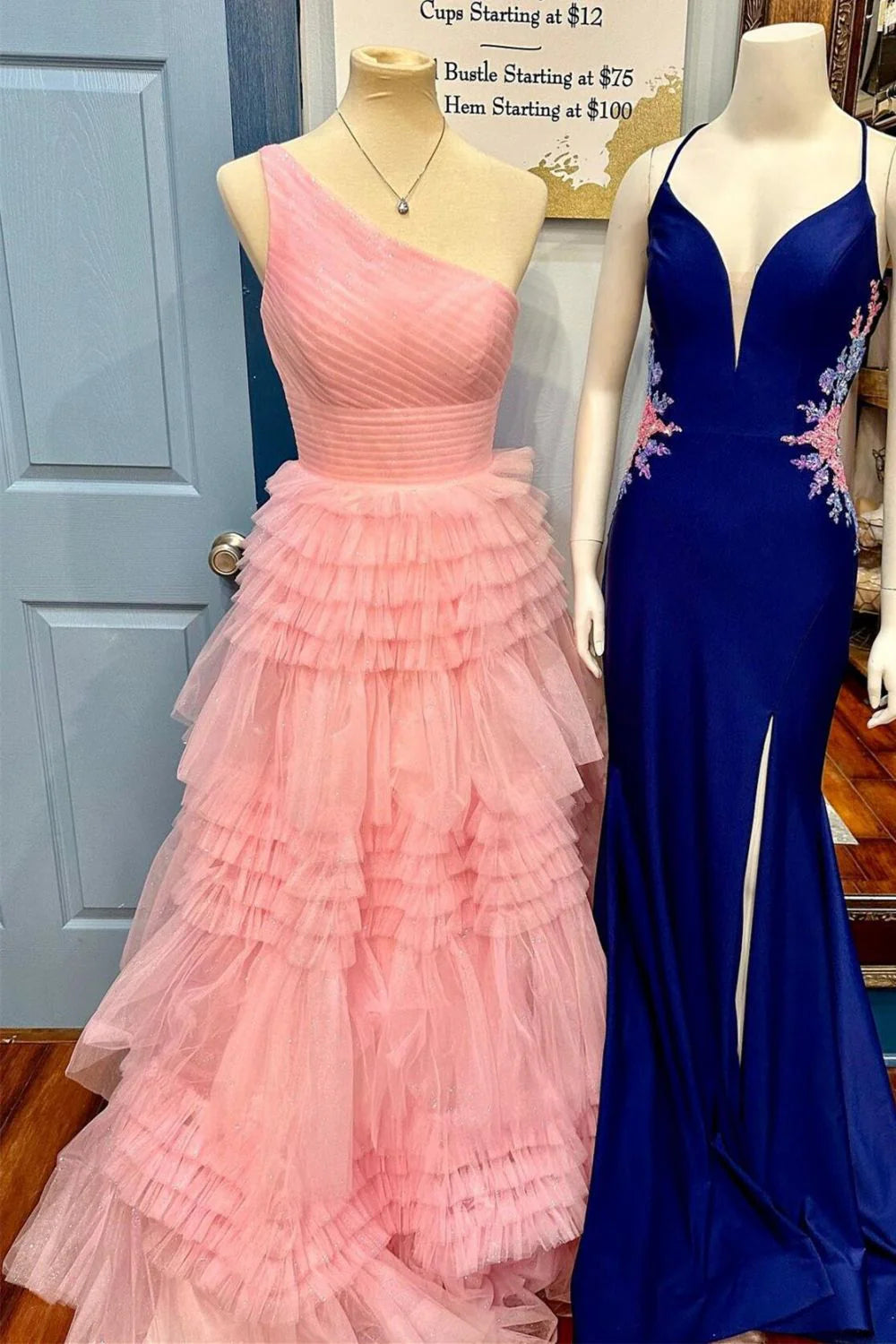 Model showcasing the intricate details of a pink A-line one-shoulder pleated tiered ruffle prom dress.