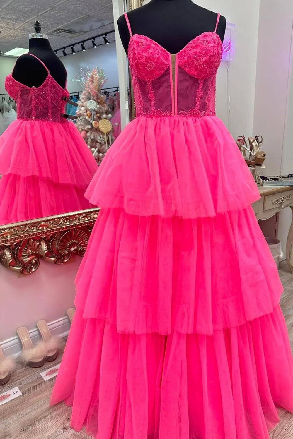 Side profile of a woman wearing the pink A-line spaghetti strap prom dress.