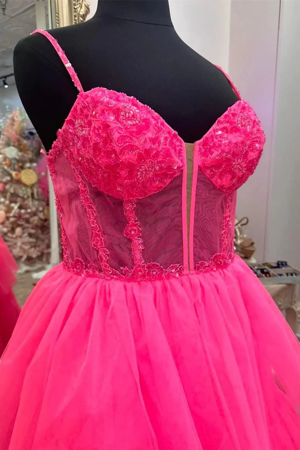 Close-up of the applique corset bodice on the pink A-line prom dress.