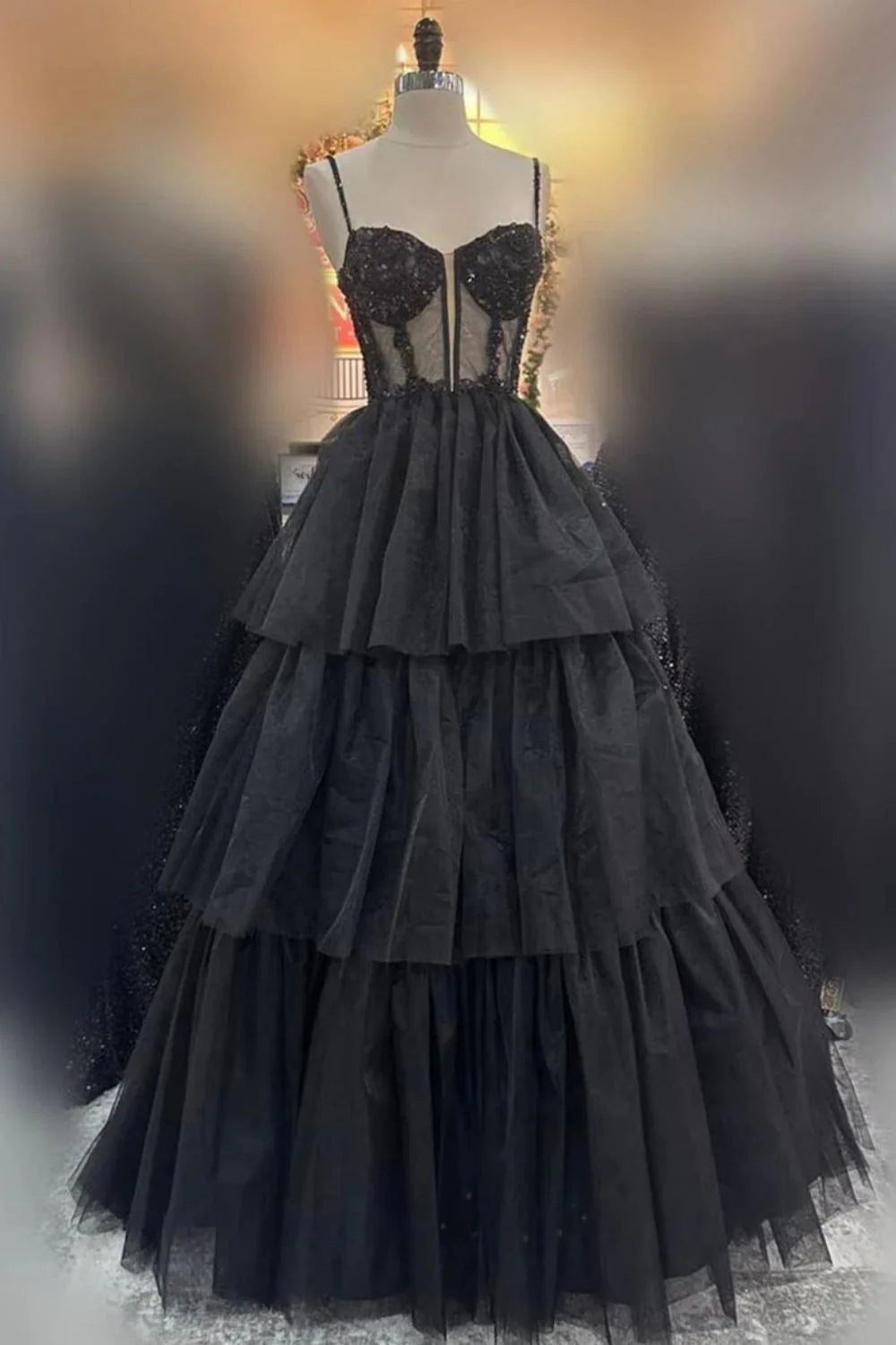 Full front view of the pink A-line prom dress with spaghetti straps and tiered skirt.