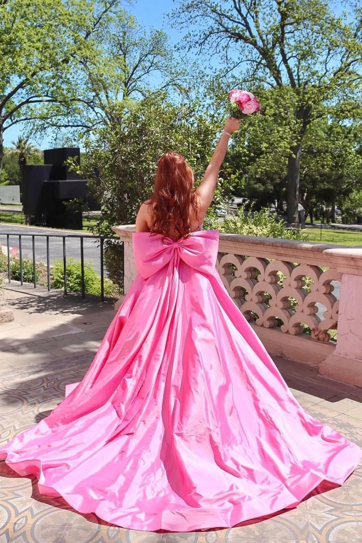Front view of pink A-line prom dress featuring spaghetti straps and sparkling beading.