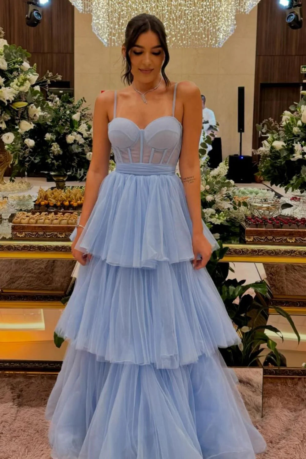 Blue A-line prom dress with tiered ruffles and spaghetti straps.