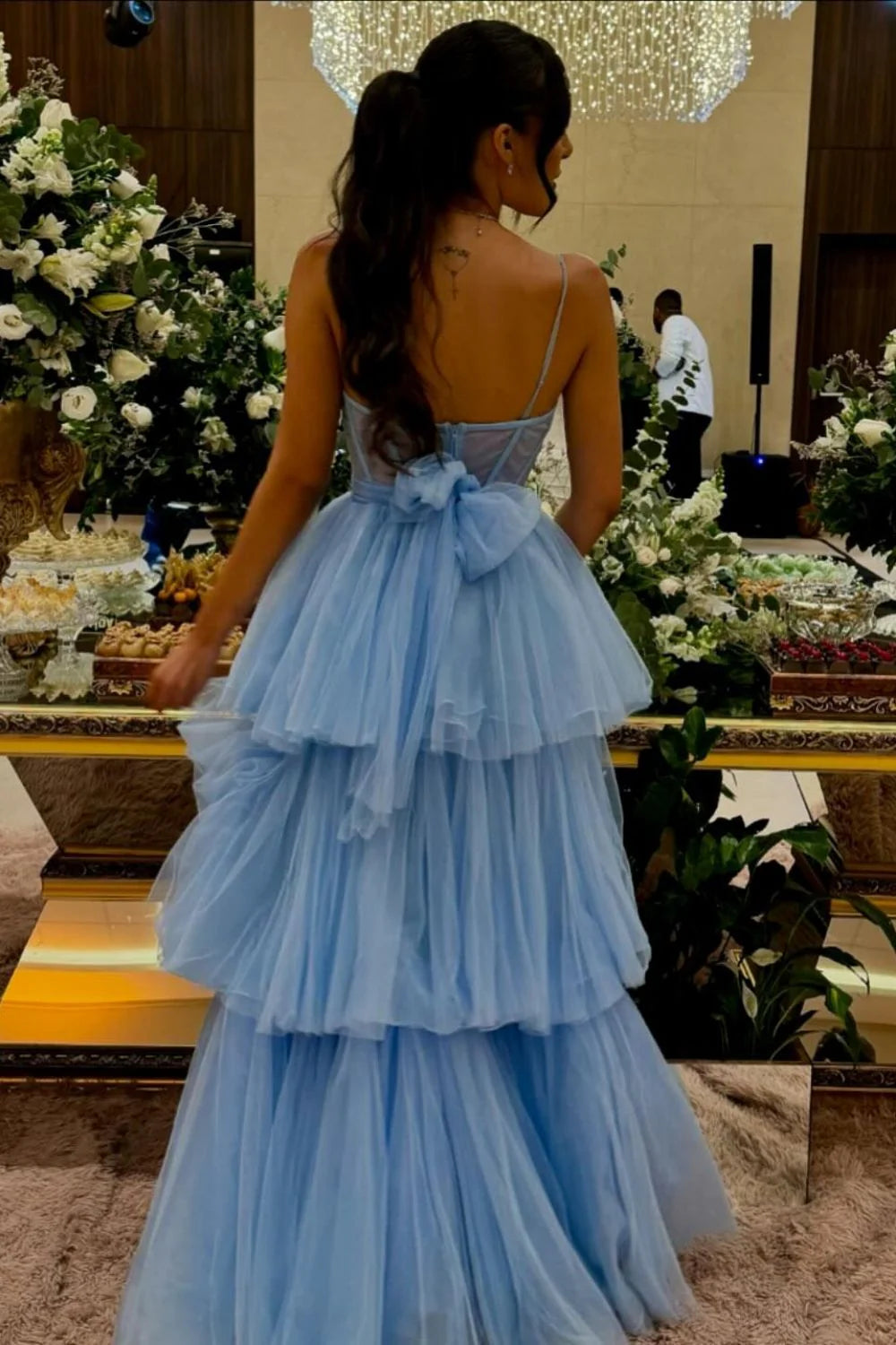 Front view of blue A-line prom dress featuring corset bodice and spaghetti straps.