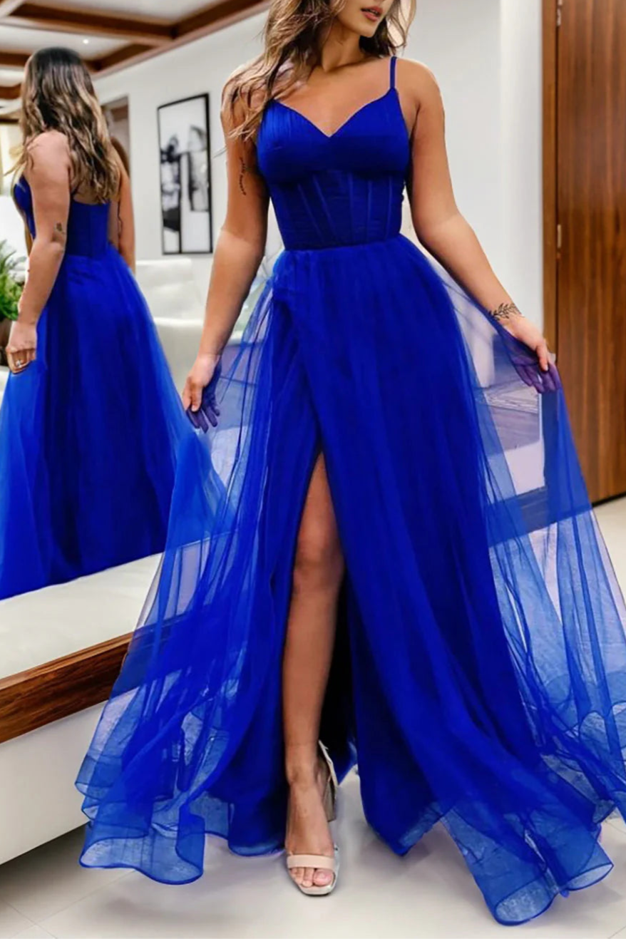 Side profile of an elegant hot pink prom dress with a flowing tulle skirt.