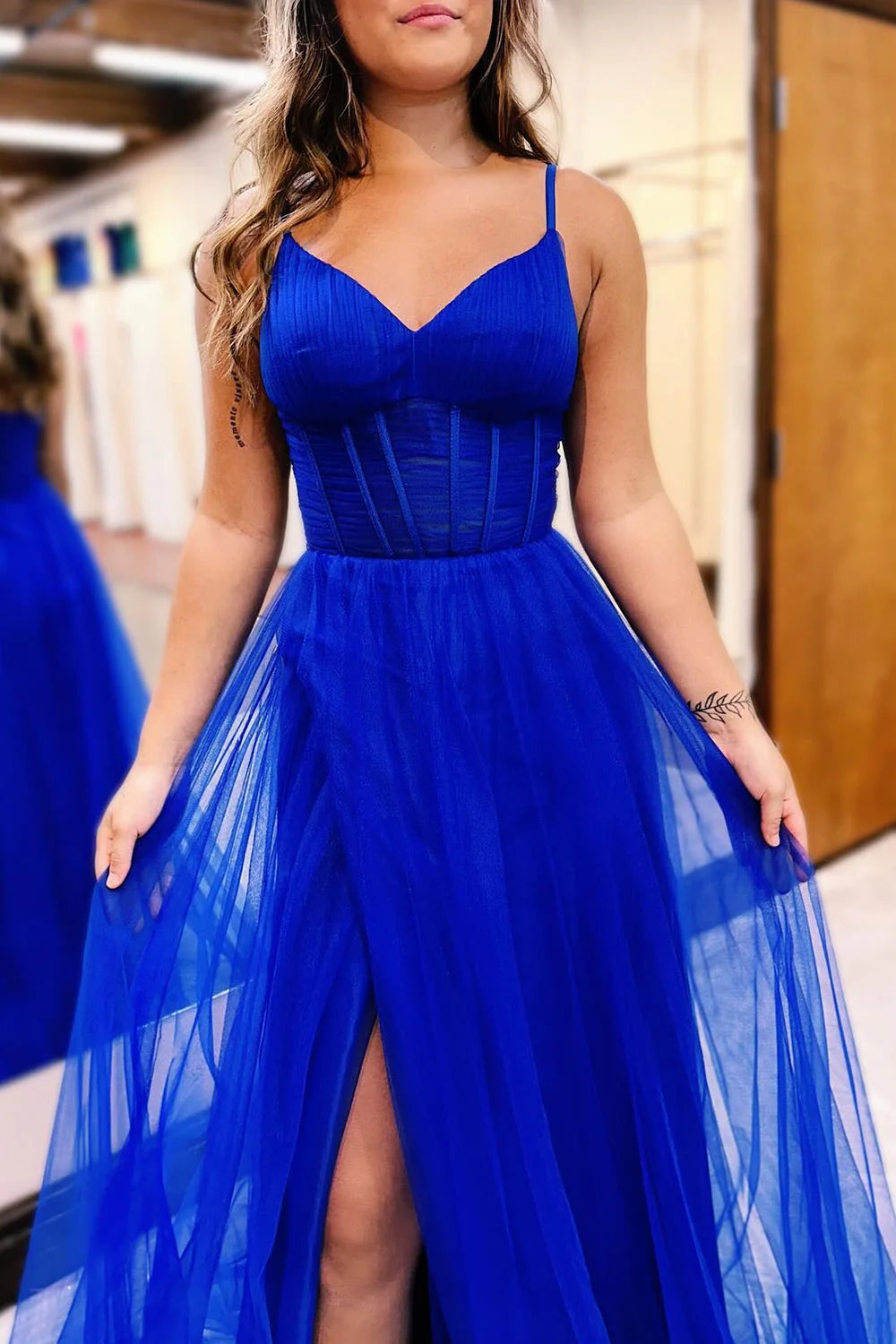 Full length view of a hot pink spaghetti strap prom dress.