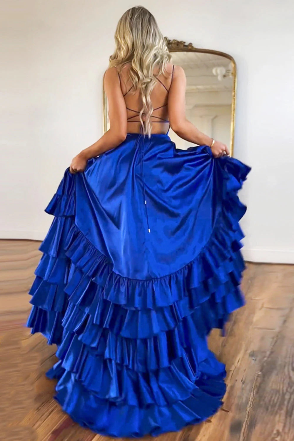 Back view of the royal blue A-line prom dress, showcasing the lace-up open back design.