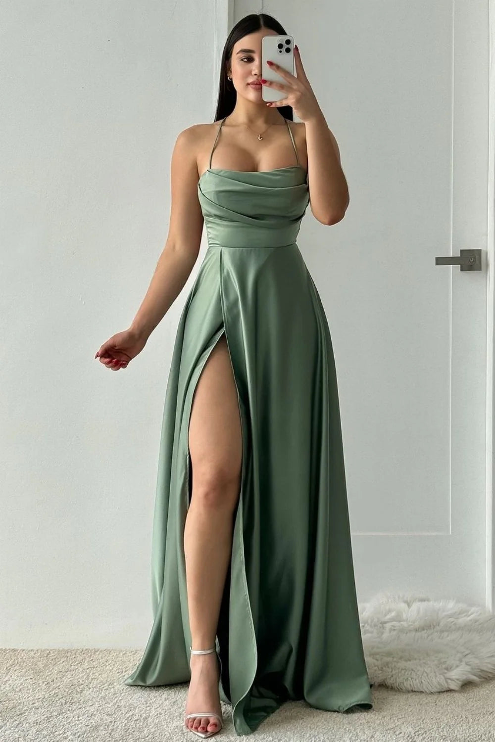Full view of an elegant dusty green A-line satin prom dress with delicate spaghetti straps.