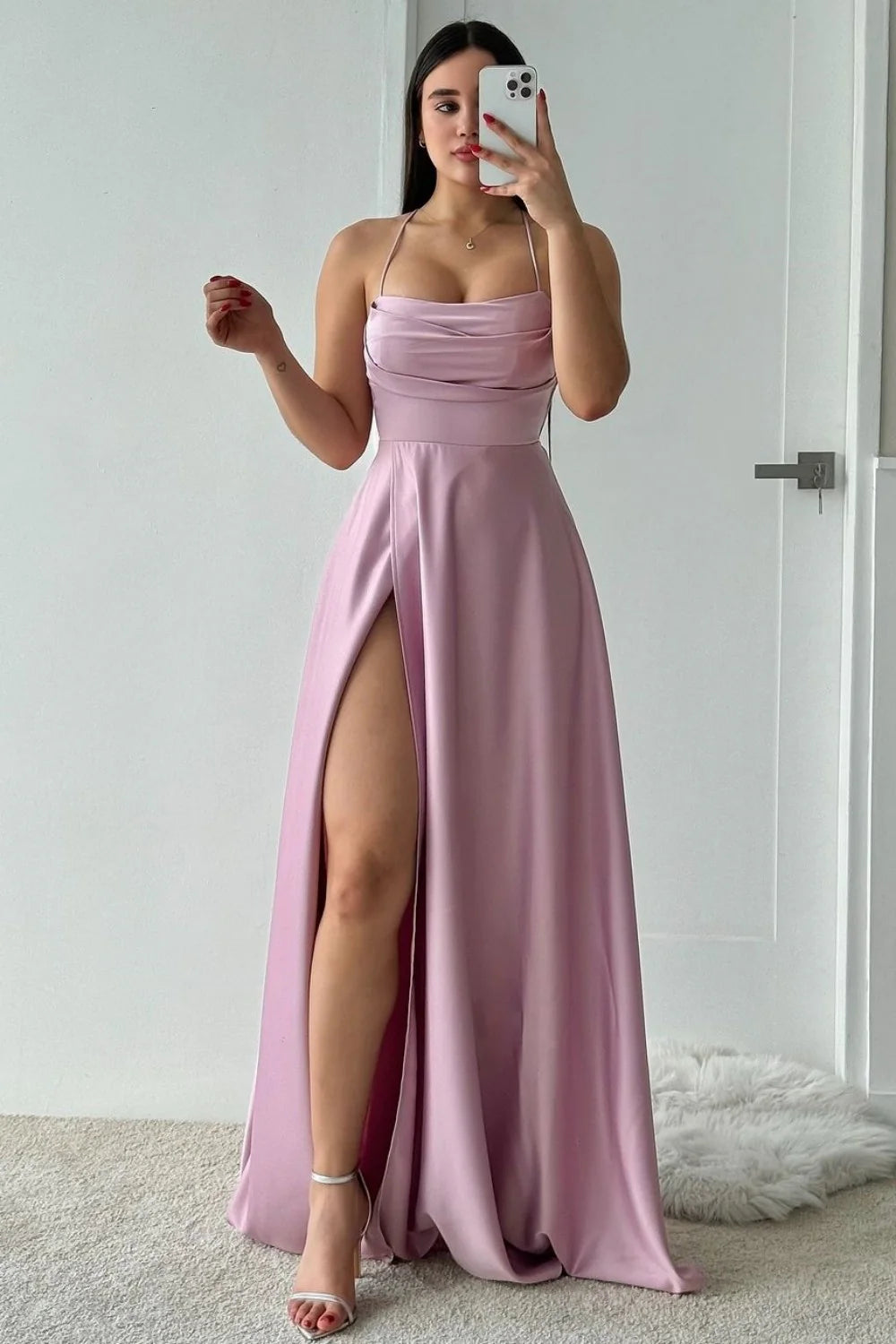 Back view of a dusty green A-line satin prom dress, showcasing the lace-up detail.