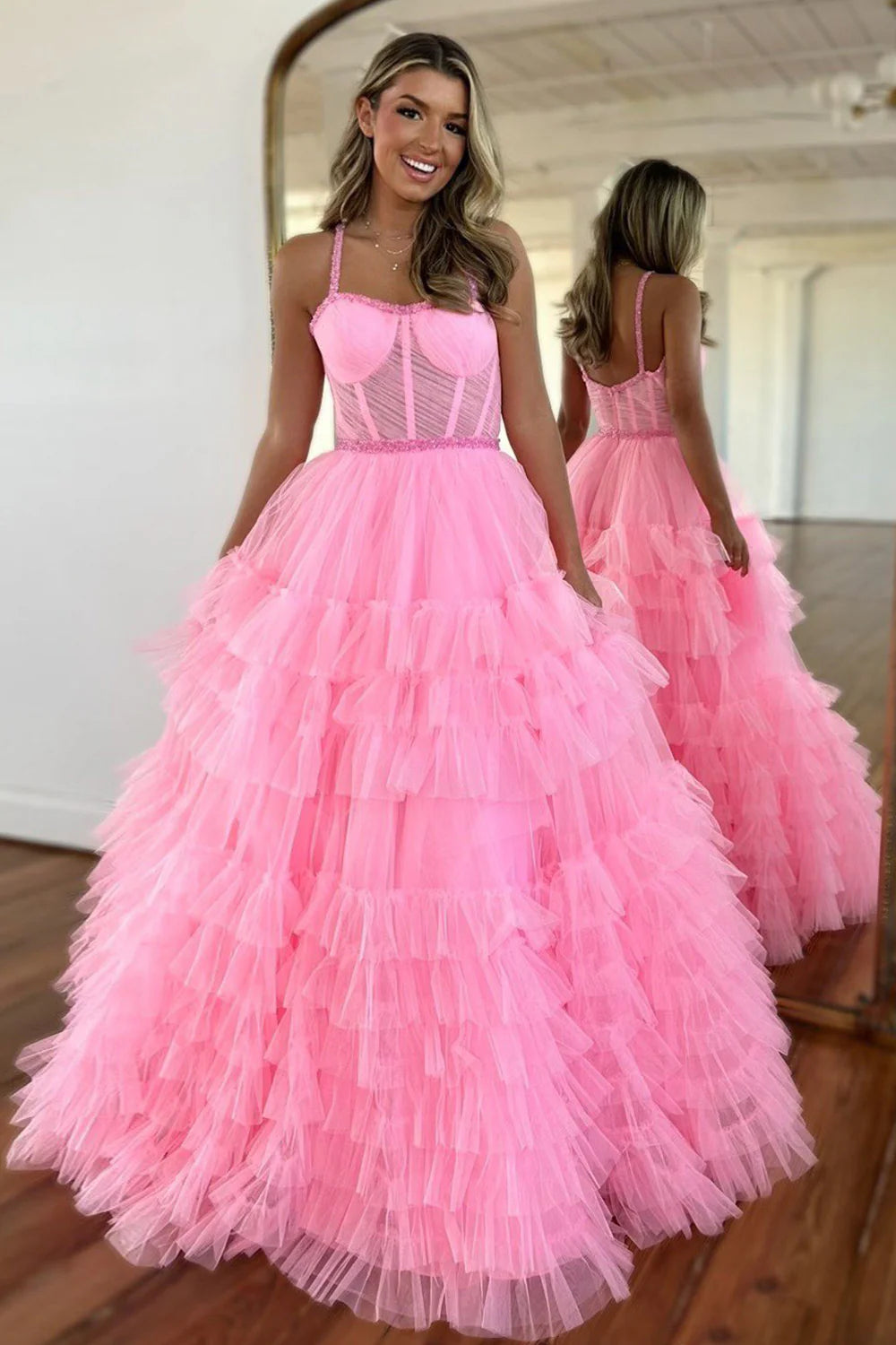 Elegant A-Line pink prom dress with spaghetti straps and tiered tulle, showcasing beaded details.