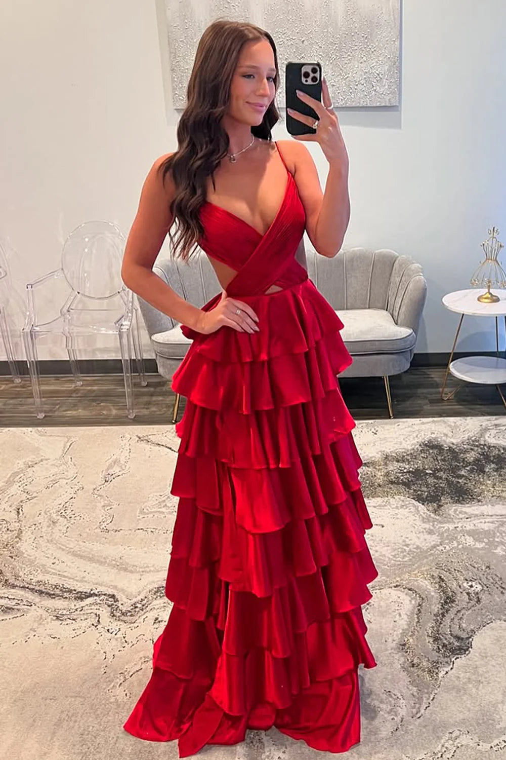 Elegant A-Line red prom dress with spaghetti straps and tiered satin skirt.