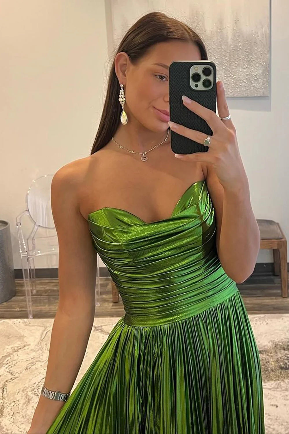 Front view of shimmering metallic green floor-length prom dress.