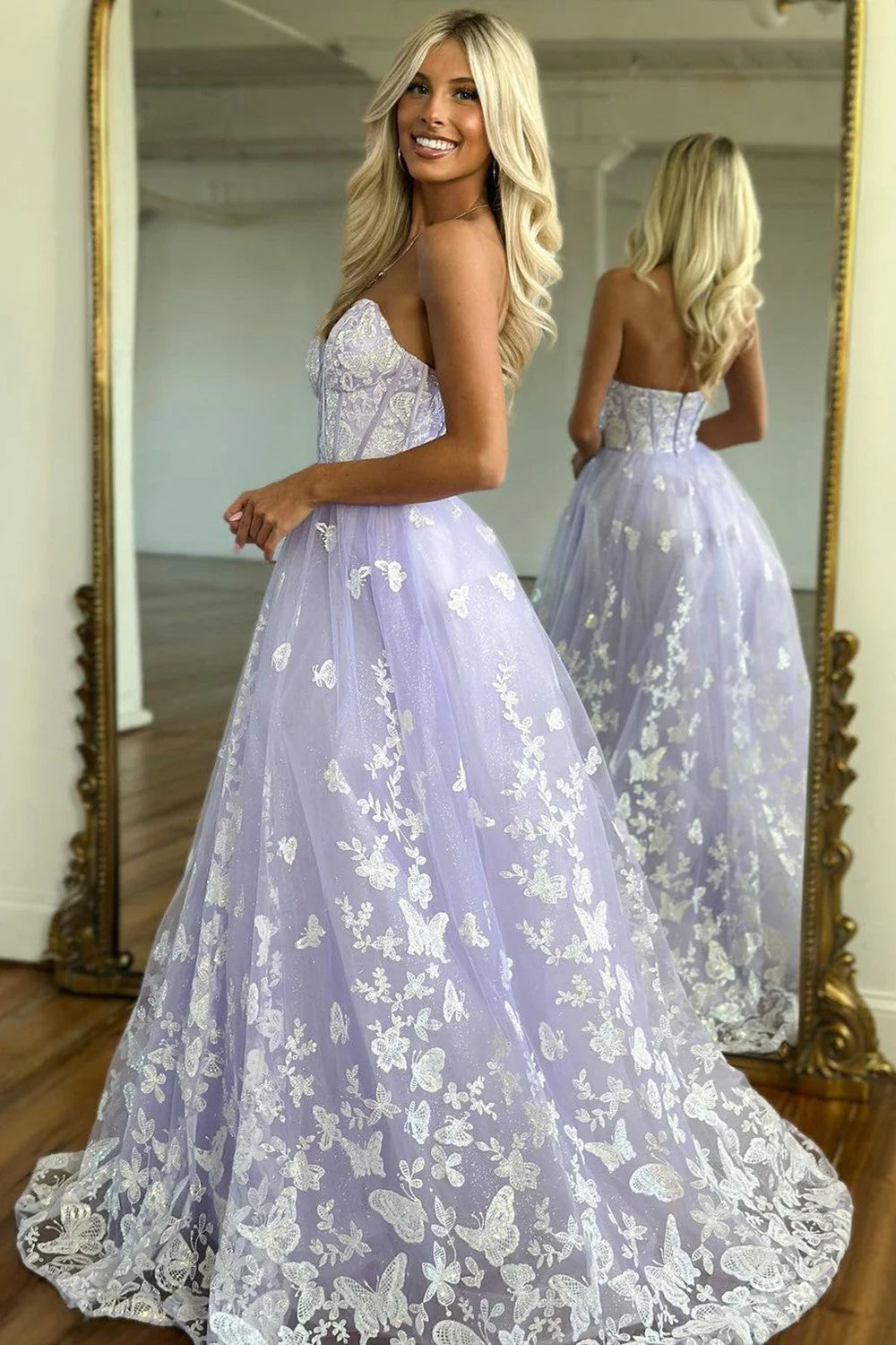 Close-up of the sweetheart neckline and delicate appliques on a lilac A-line prom dress.