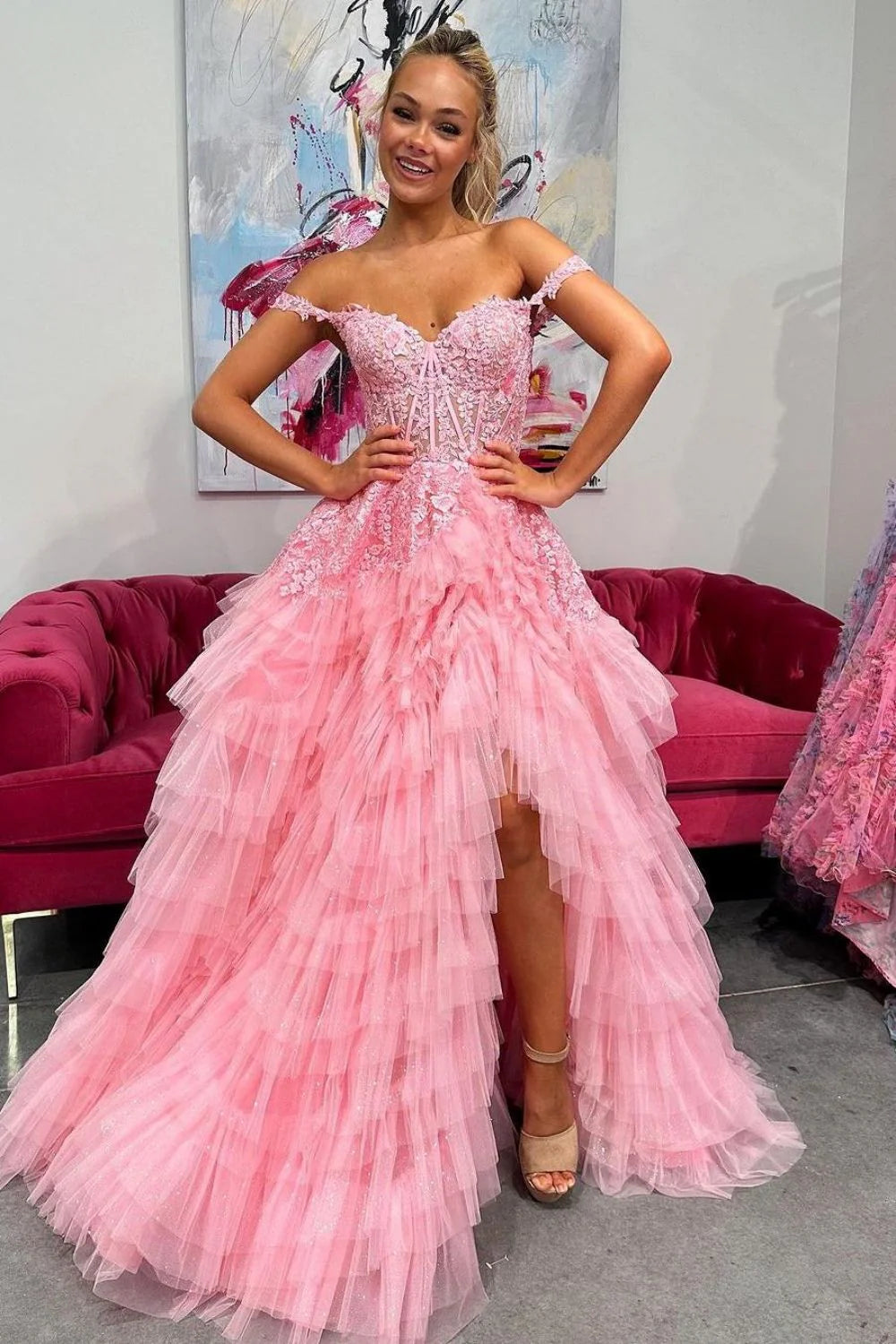 Elegant pink A-line prom dress with sweetheart neckline, delicate appliques, tiered tulle skirt, and a stylish high slit.