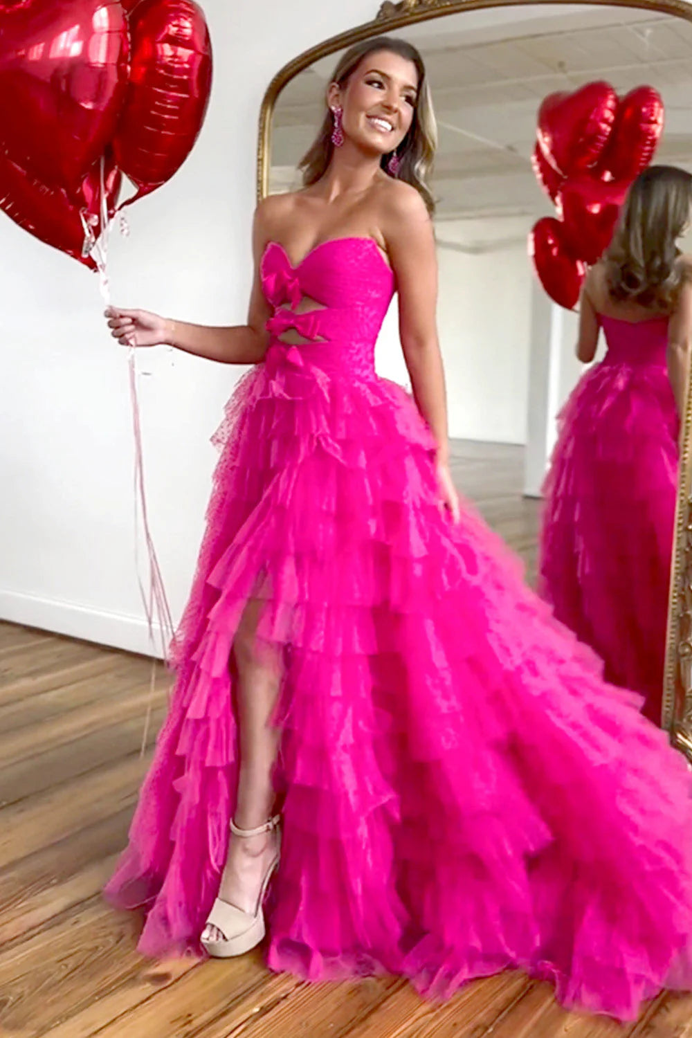 Back view of the fuchsia A-line prom dress, showing the zipper closure and flowing tiered tulle.