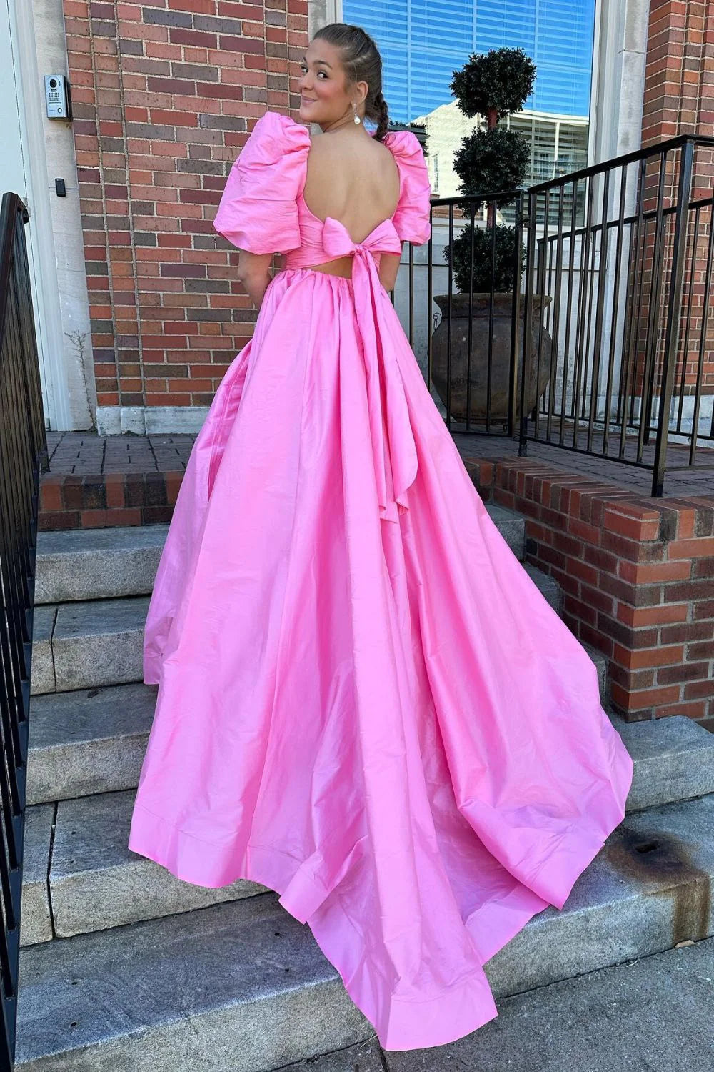 Back view of fuchsia prom dress showing tie-bow detail and corset.