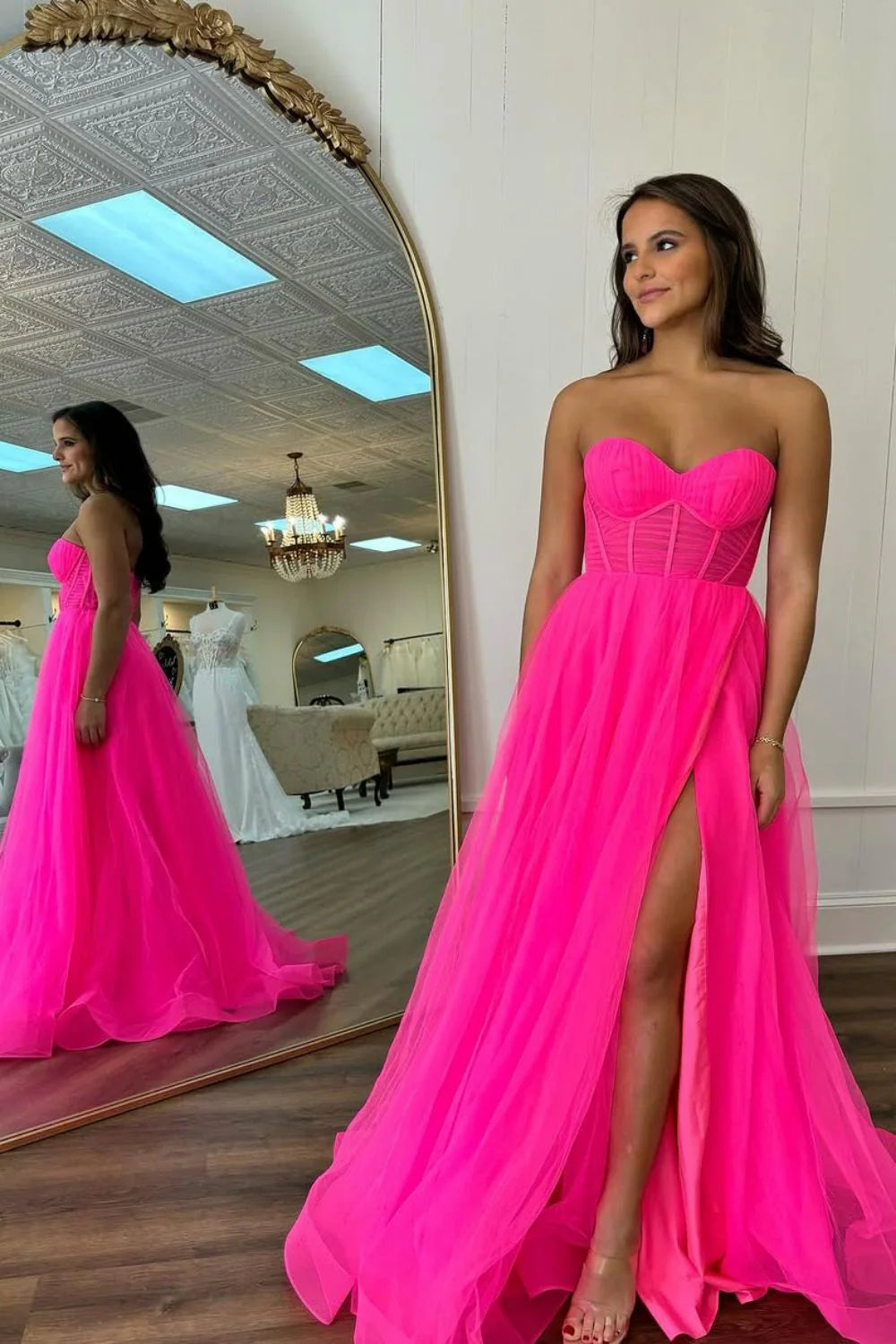 Full view of a hot pink A-line sweetheart tulle prom dress with a sweep-brush train.