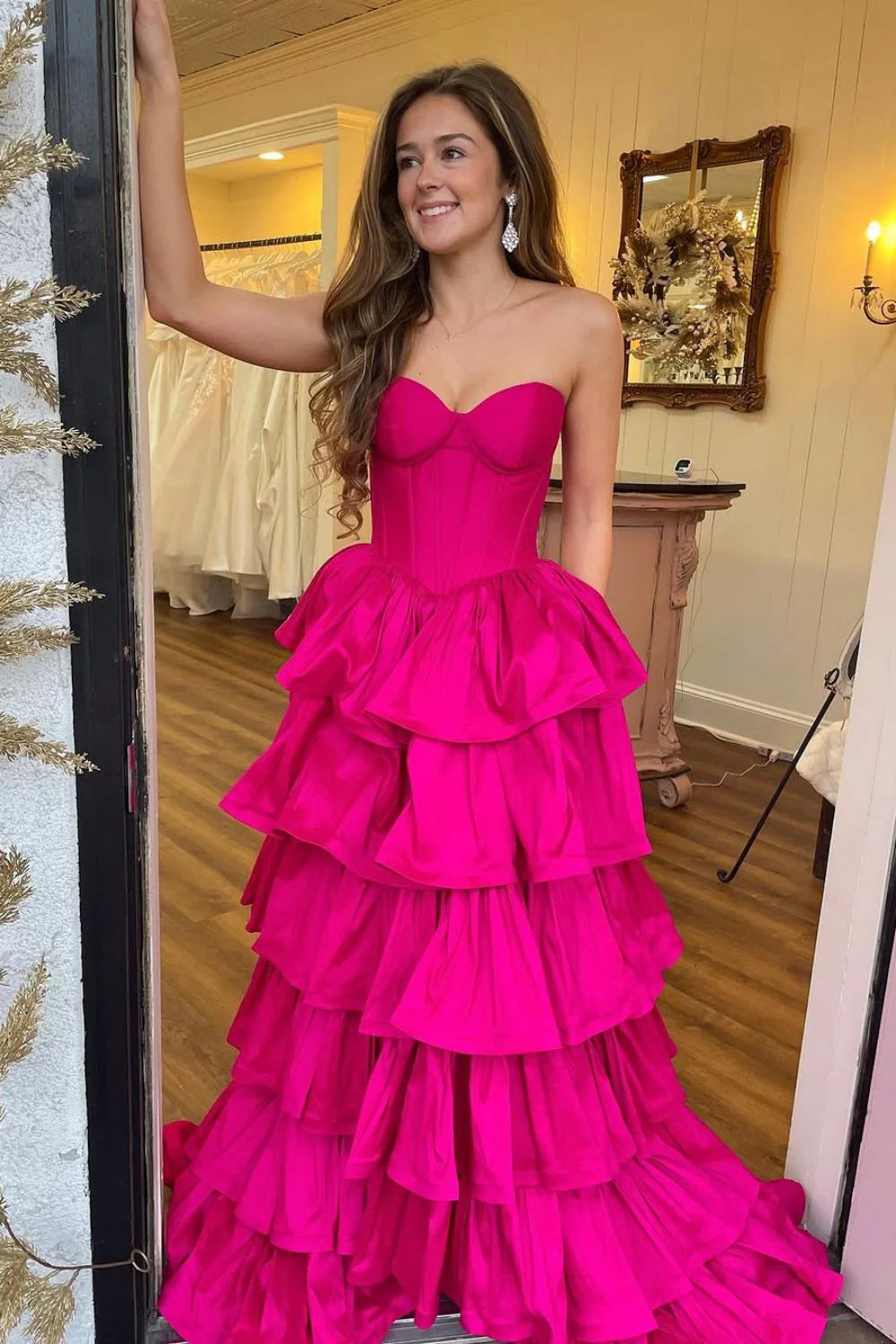 Hot pink A-line prom dress with sweetheart neckline and tiered satin skirt.