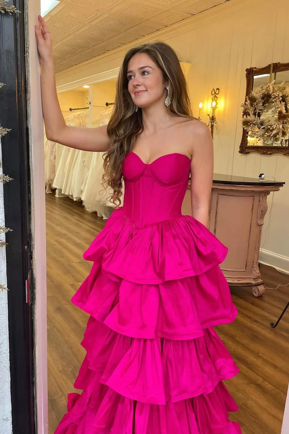 Full-length hot pink satin prom dress featuring a tiered A-line silhouette.
