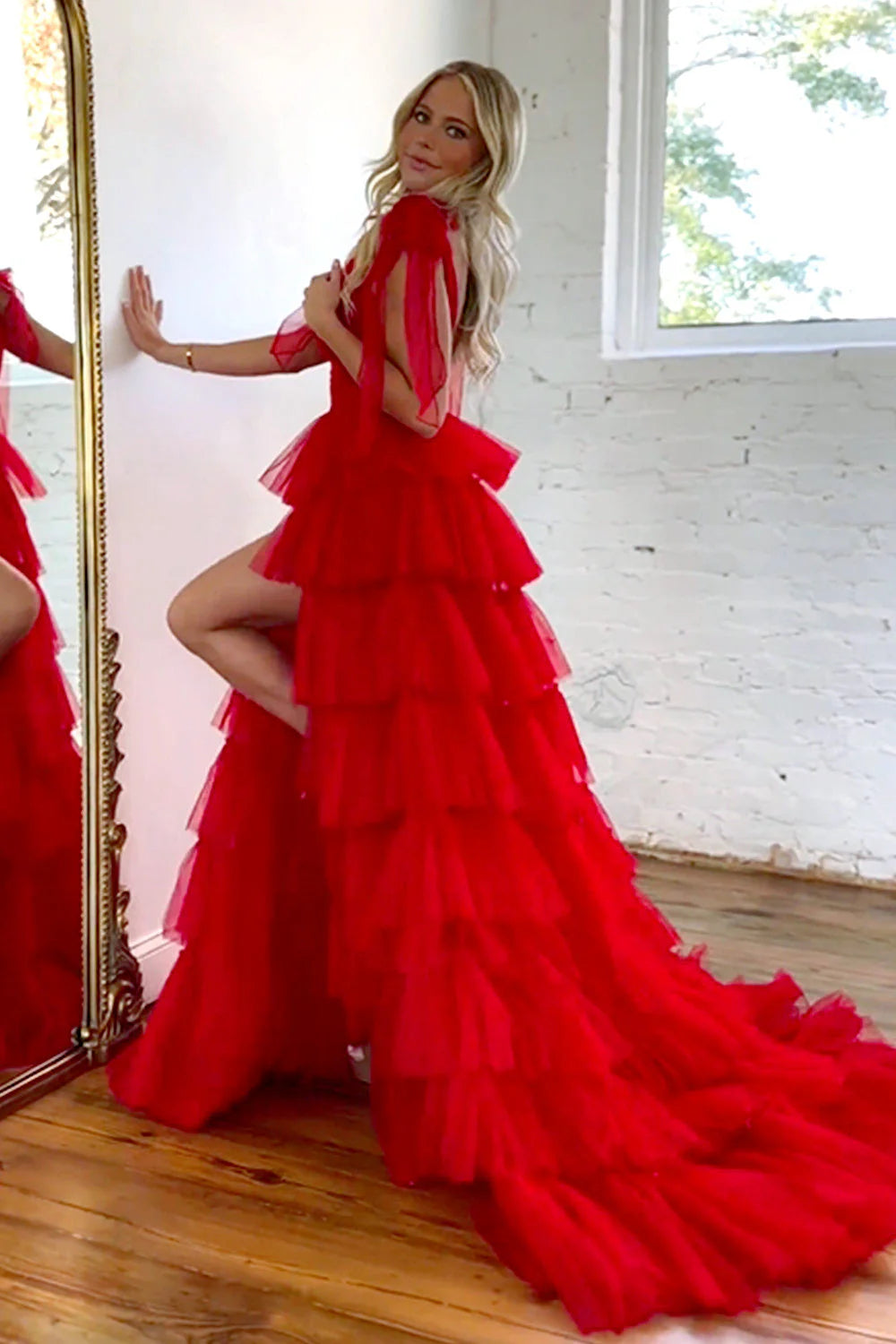 Front view of a red A-line prom dress featuring a V-neckline and ruffles.