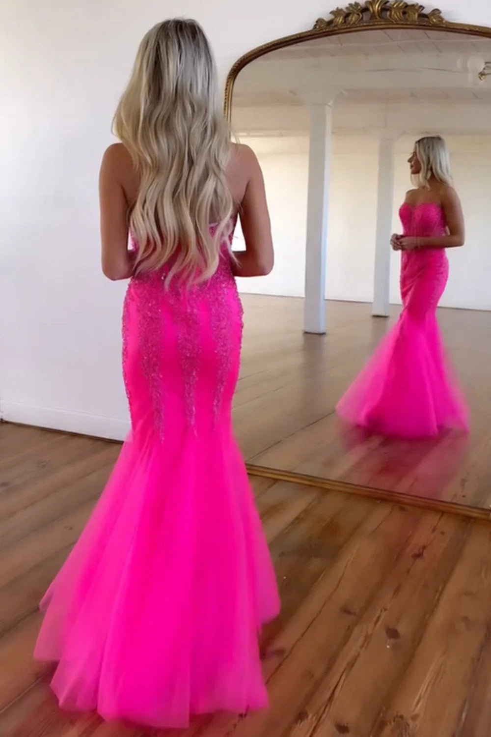 Full view of the hot pink mermaid prom dress, showcasing the corset bodice and floor-length design.