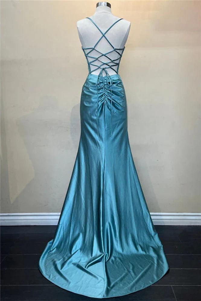 Back view of the green mermaid dress showing the criss-cross lace-up design.