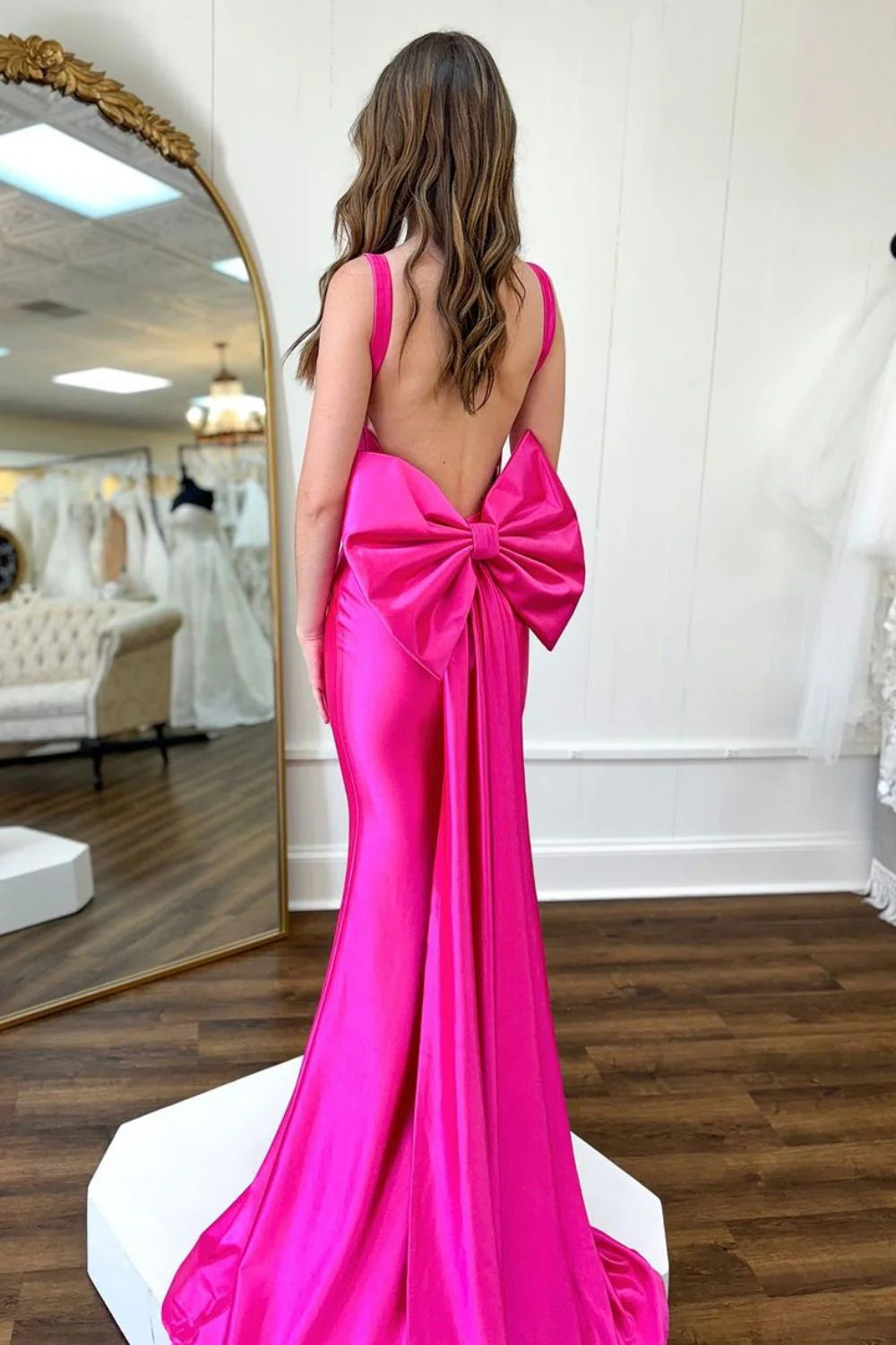 Hot pink mermaid prom dress, front view, featuring a square neck and smooth satin fabric.