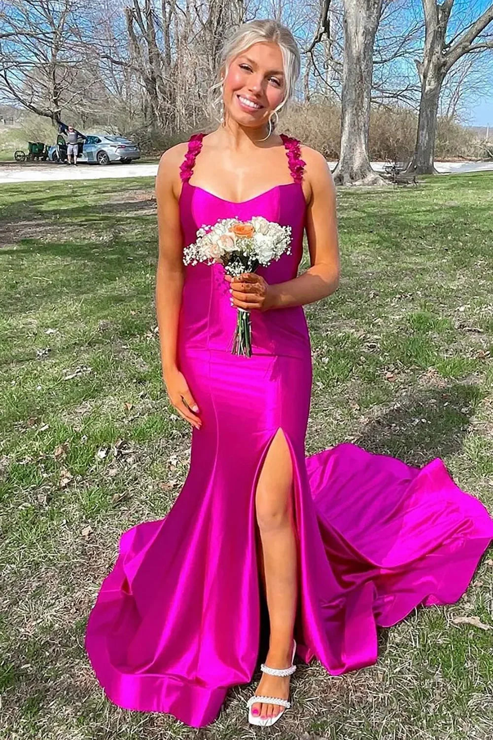 Close-up of applique straps and sweetheart neckline on red prom dress.