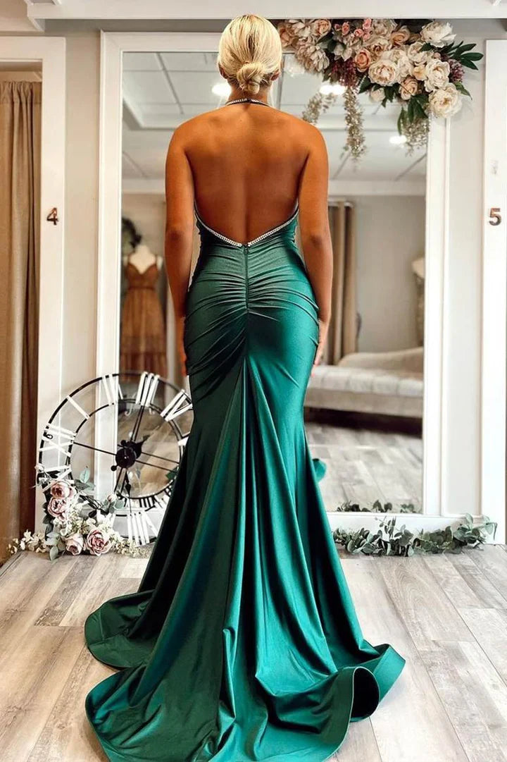 Back view of the royal blue prom dress, highlighting the open back and train.