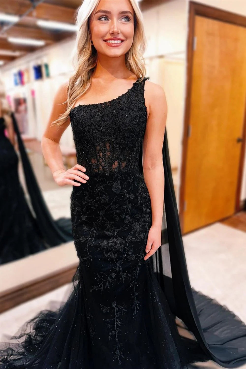 Elegant black prom dress featuring a mermaid silhouette, one shoulder, and delicate lace details.