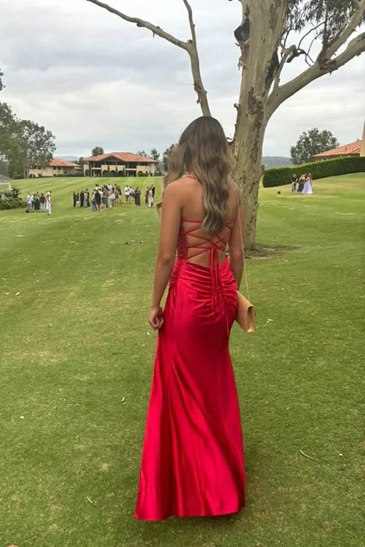 Back view of a red mermaid prom dress showing lace-up corset detail.