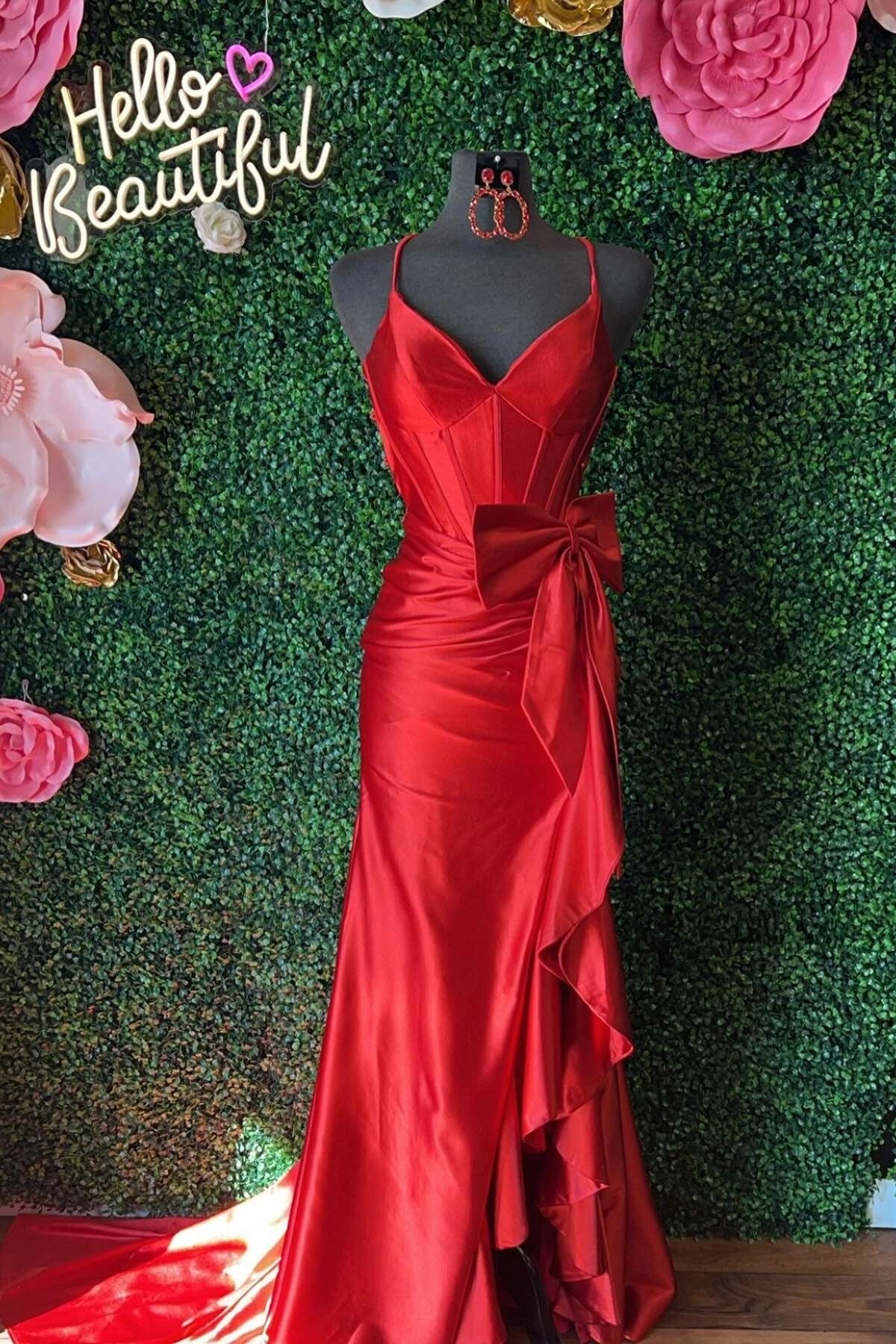 Full-length view of a model in a hot pink mermaid prom dress with a high slit.