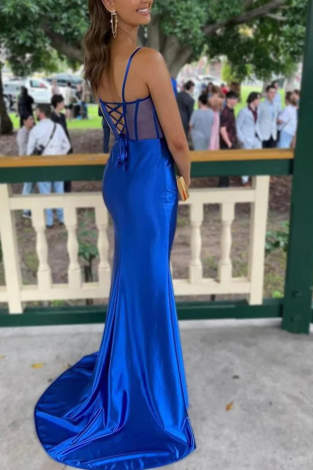 Back view of the royal blue satin mermaid gown featuring a lace-up closure.