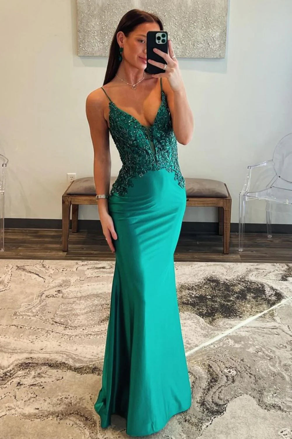 Elegant dark green mermaid prom dress with spaghetti straps and intricate beading.