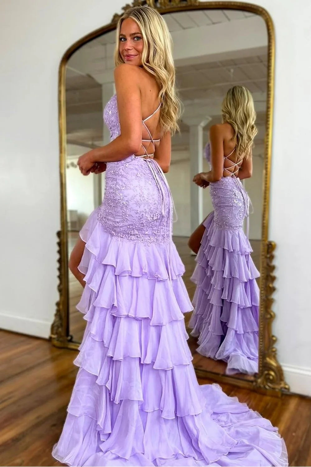 Back view of a lilac mermaid prom dress showing lace-up detail and sweep train.