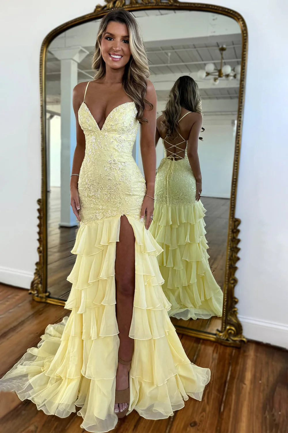 Side profile of a woman wearing a lilac mermaid gown, highlighting the silhouette and train.