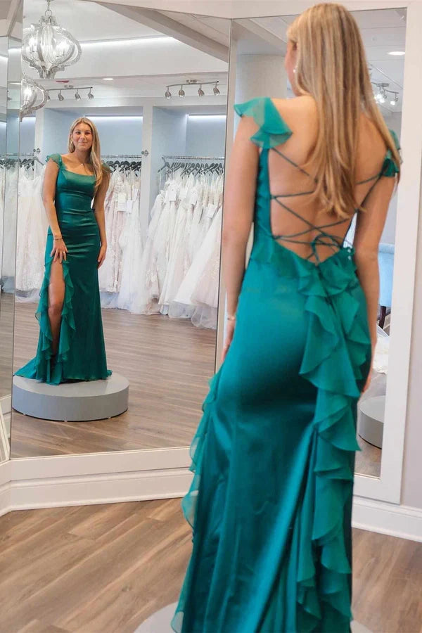 Full view of the green long prom dress, highlighting the mermaid silhouette and slit.