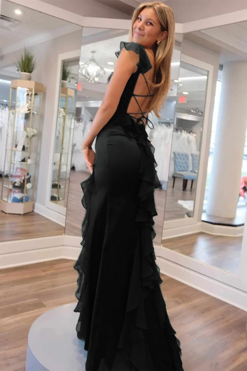 Side profile of the green mermaid prom dress, emphasizing its elegant fit.